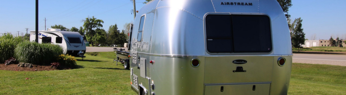 Airstream® Sport 16 parked in a grassy manicured lot on a sunny day.